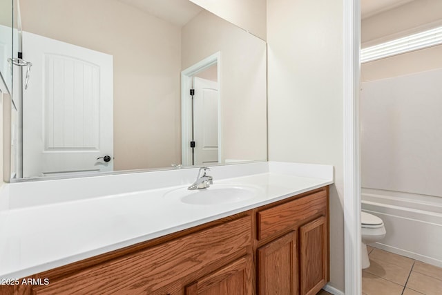 bathroom featuring tile patterned flooring, vanity, and toilet