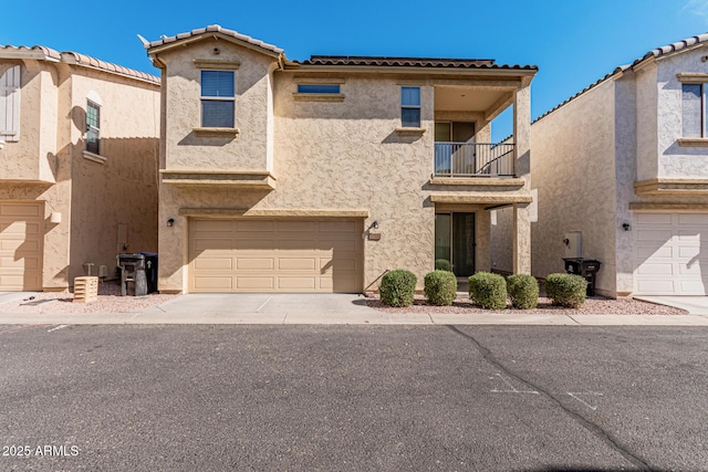 view of front of property with a balcony and a garage