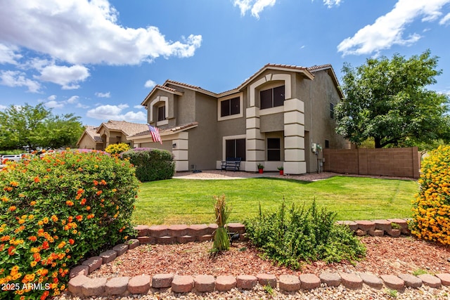 rear view of house featuring stucco siding, a tile roof, and a patio