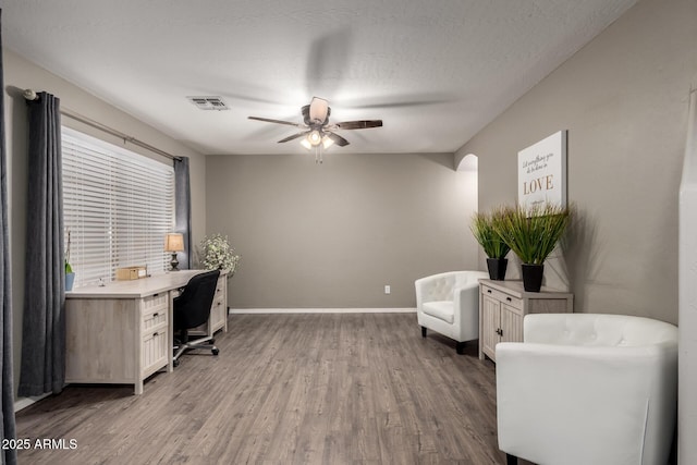 office space featuring ceiling fan, wood finished floors, and baseboards