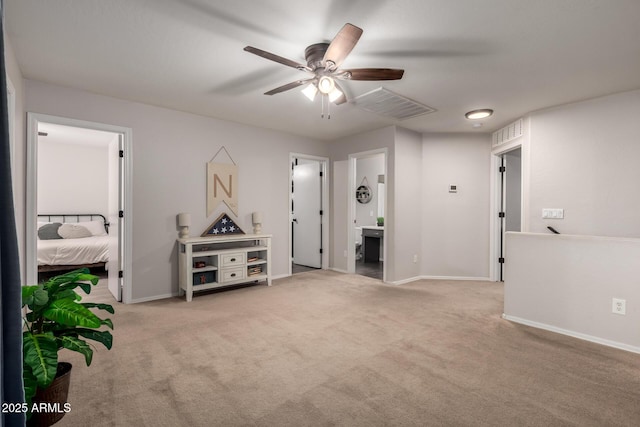 carpeted spare room featuring ceiling fan and baseboards