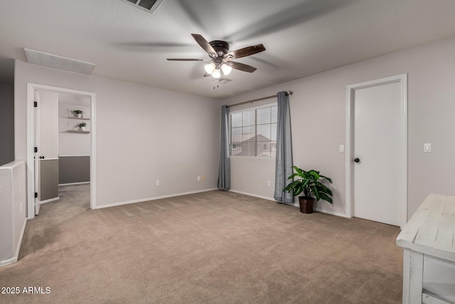 unfurnished bedroom with light colored carpet, baseboards, and ceiling fan