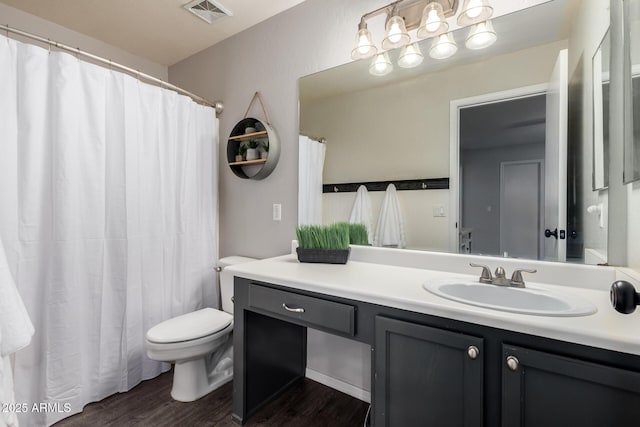 full bathroom featuring wood finished floors, vanity, and toilet
