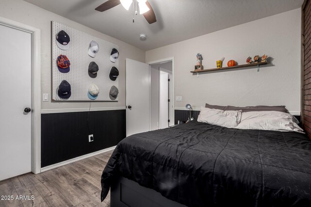 bedroom with wood finished floors and a ceiling fan