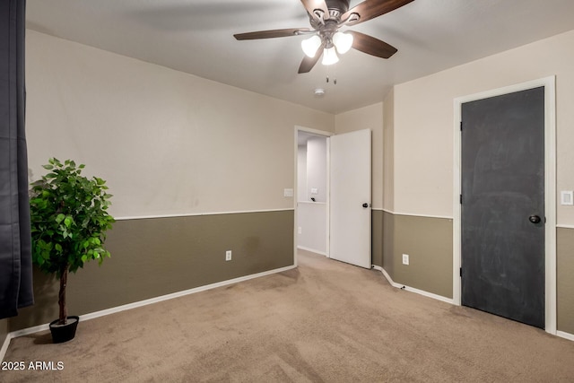 unfurnished bedroom featuring carpet flooring, baseboards, and ceiling fan