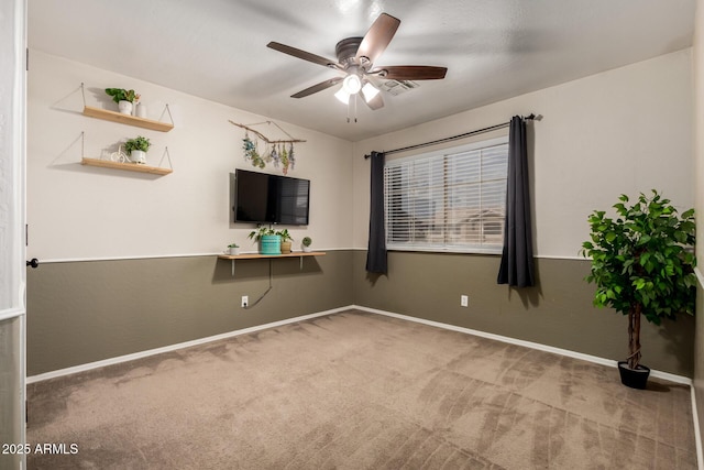 interior space with carpet flooring, baseboards, and a ceiling fan