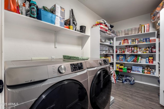 laundry area featuring washing machine and dryer and wood finished floors