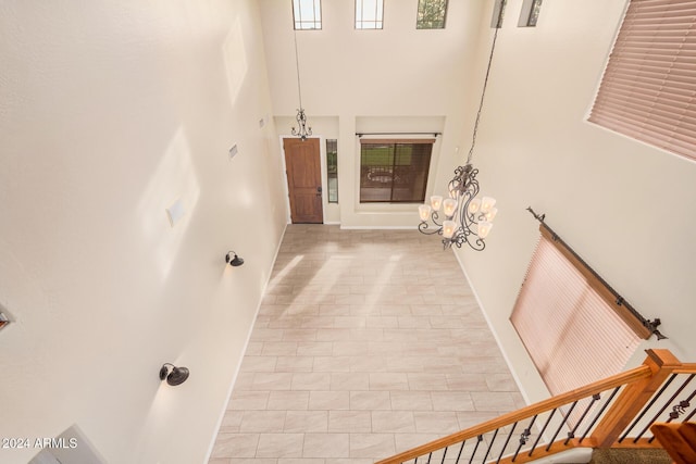 322 E Caribbean Dr, Casa Grande, AZ 85122 - stairs featuring a towering ceiling, baseboards, and tile patterned flooring