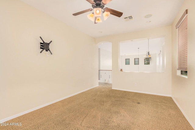 322 E Caribbean Dr, Casa Grande, AZ 85122 - spare room with carpet floors, a ceiling fan, baseboards, and arched walkways