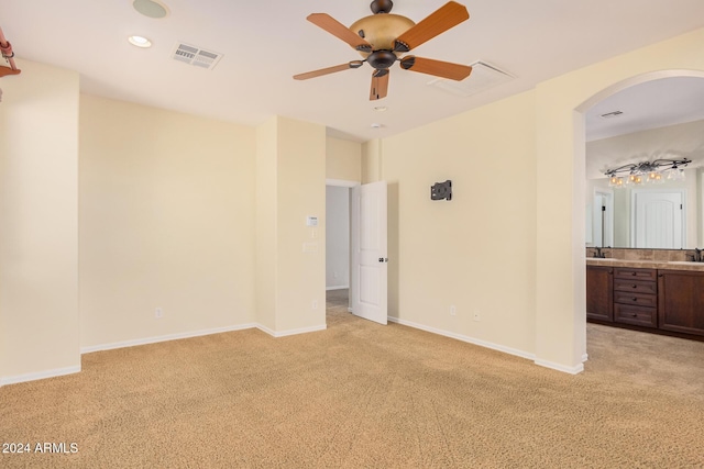 322 E Caribbean Dr, Casa Grande, AZ 85122 - unfurnished bedroom featuring light carpet, arched walkways, baseboards, and recessed lighting