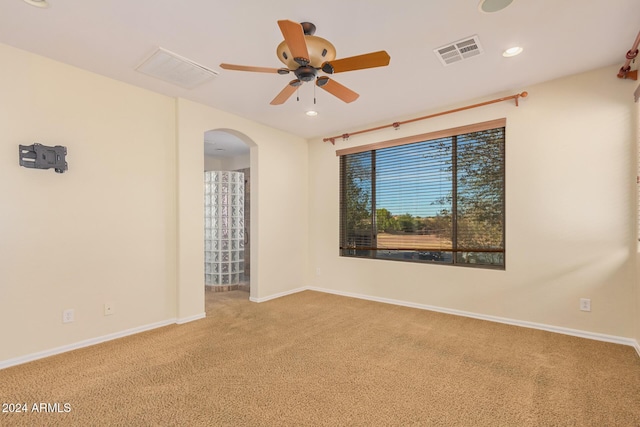 322 E Caribbean Dr, Casa Grande, AZ 85122 - empty room with arched walkways, carpet, ceiling fan, baseboards, and recessed lighting