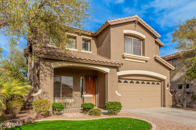 322 E Caribbean Dr, Casa Grande, AZ 85122 - mediterranean / spanish home featuring a garage, a tiled roof, stucco siding, concrete driveway, and a porch