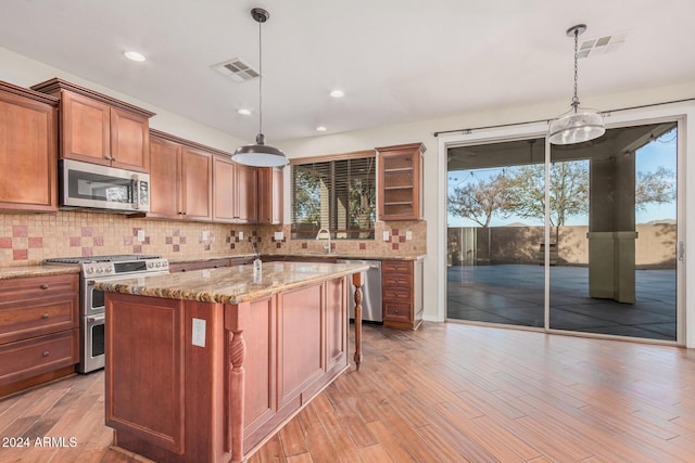 322 E Caribbean Dr, Casa Grande, AZ 85122 - kitchen featuring appliances with stainless steel finishes, a sink, healthy amount of natural light, light stone countertops, and recessed lighting