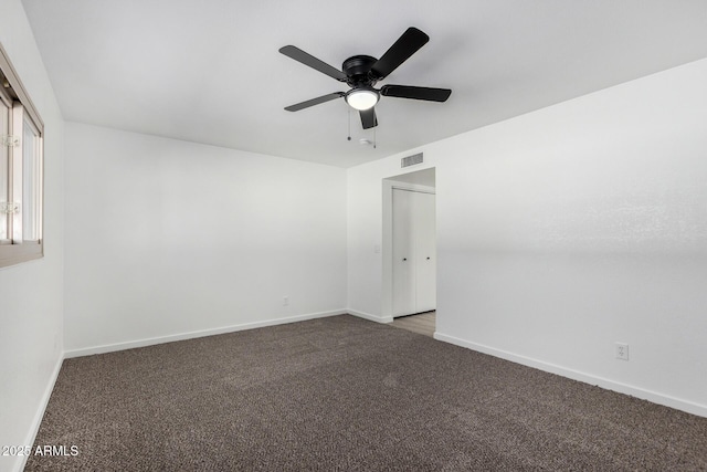 carpeted empty room featuring ceiling fan