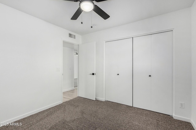 unfurnished bedroom with light colored carpet, a closet, and ceiling fan