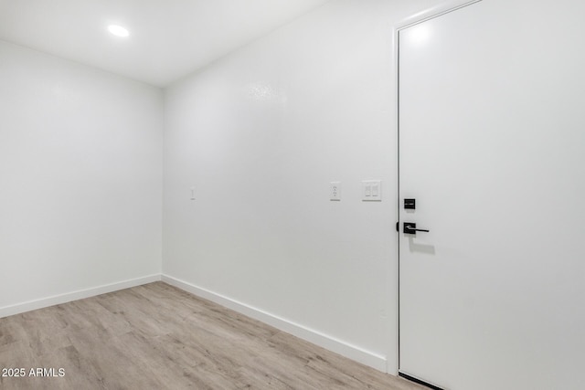 unfurnished room with light wood-type flooring