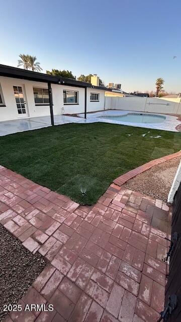 view of yard featuring a pool and a patio