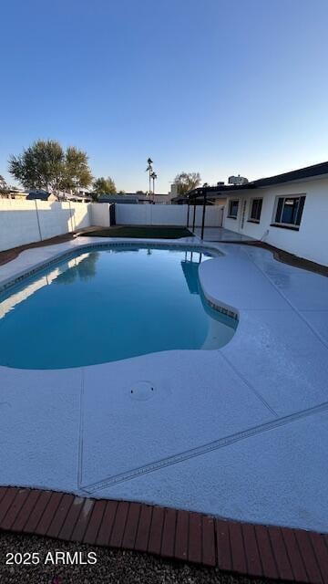 view of swimming pool with a patio