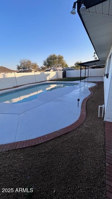 view of swimming pool with a patio area