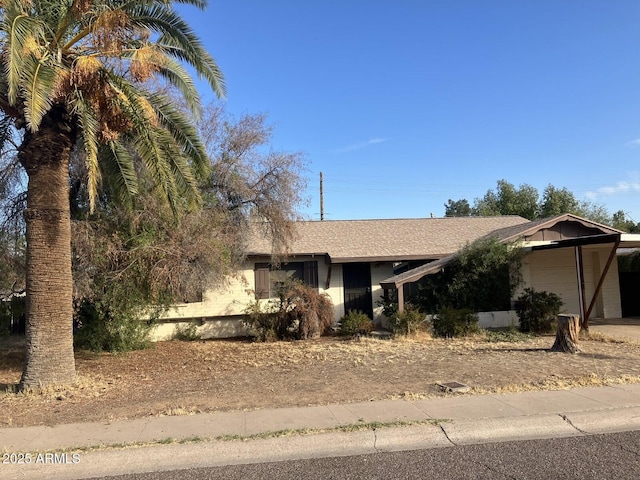 view of front of property featuring a carport