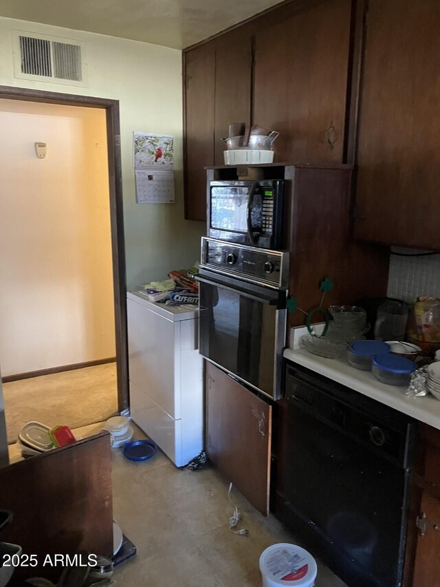 9033 N 15th Dr, Phoenix, AZ 85021 - kitchen with black appliances, light countertops, and dark brown cabinetry