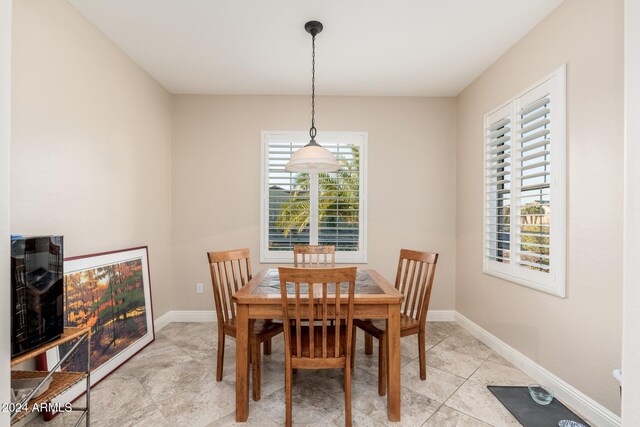 dining space with light tile patterned floors