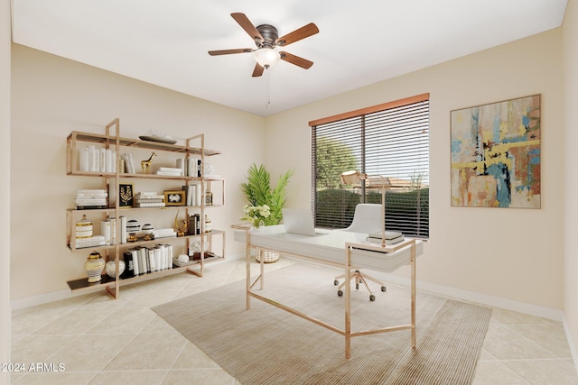 tiled home office featuring ceiling fan