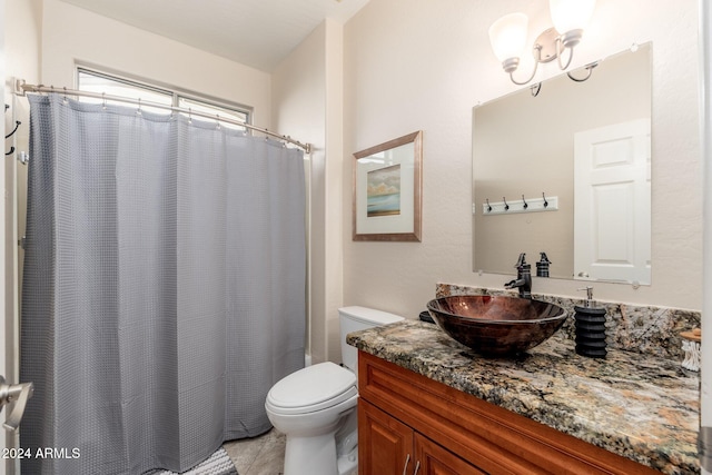 bathroom featuring tile patterned flooring, vanity, and toilet