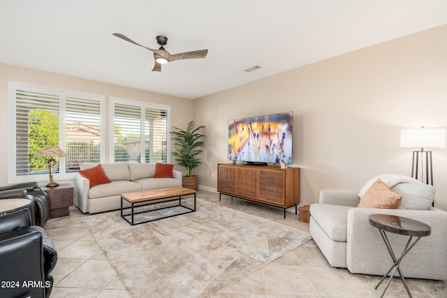 living room with ceiling fan and light tile patterned flooring