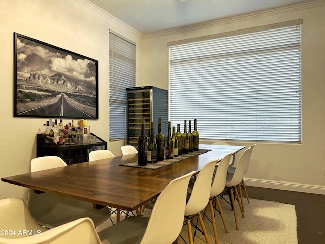 dining area with indoor bar, beverage cooler, and crown molding