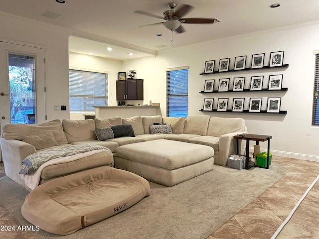 living room featuring ceiling fan, crown molding, and light tile patterned flooring