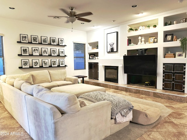 living room featuring tile patterned flooring, ceiling fan, built in features, and ornamental molding