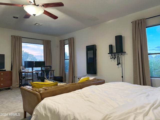 bedroom featuring ceiling fan and light carpet