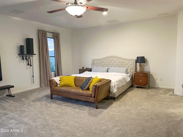 bedroom with ceiling fan and light carpet