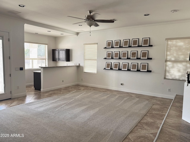 unfurnished living room with ceiling fan, light tile patterned flooring, and ornamental molding