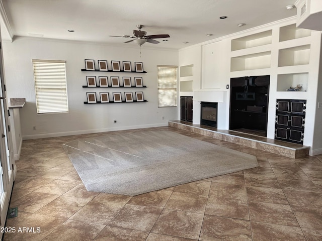 unfurnished living room with tile patterned floors, built in features, ceiling fan, and ornamental molding