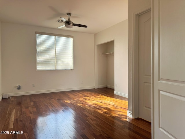 unfurnished bedroom featuring ceiling fan, dark hardwood / wood-style flooring, and a closet