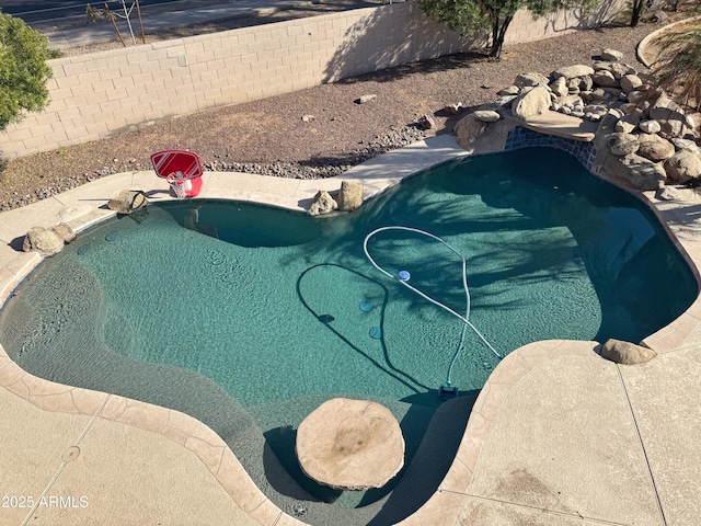 view of swimming pool featuring a hot tub