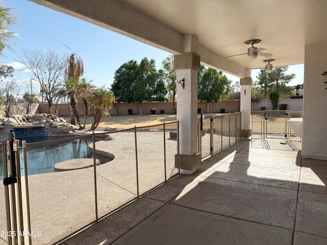 view of patio featuring a fenced in pool and ceiling fan