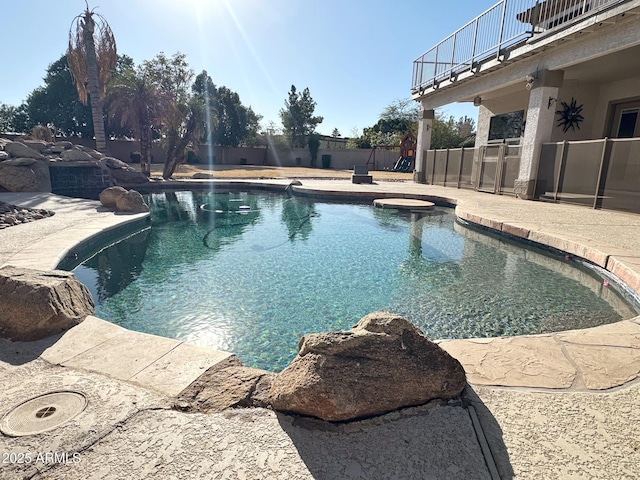 view of pool with a hot tub