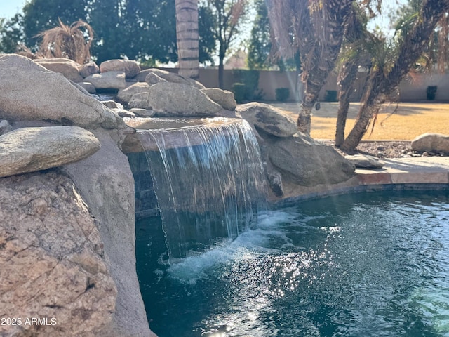 view of swimming pool featuring pool water feature