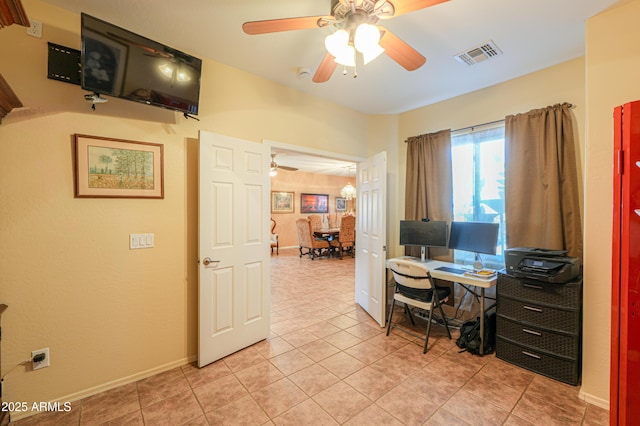office with light tile patterned floors, a ceiling fan, visible vents, and baseboards