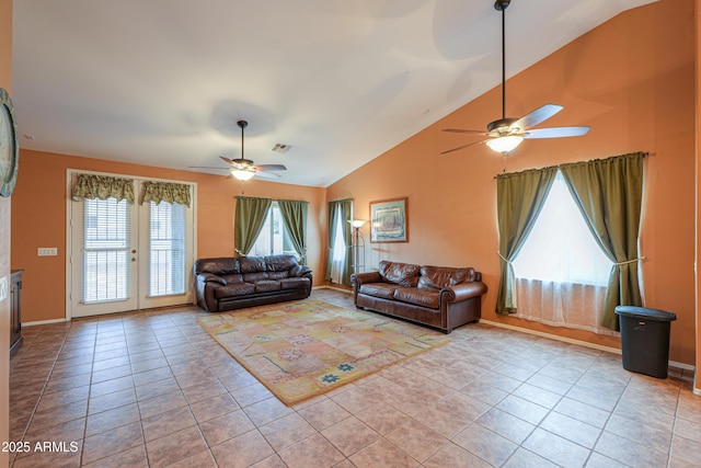 living area featuring french doors, light tile patterned floors, lofted ceiling, visible vents, and a ceiling fan