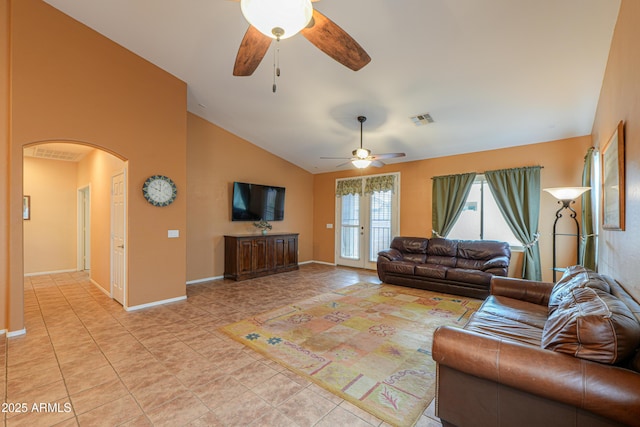 living area with arched walkways, ceiling fan, light tile patterned floors, lofted ceiling, and visible vents