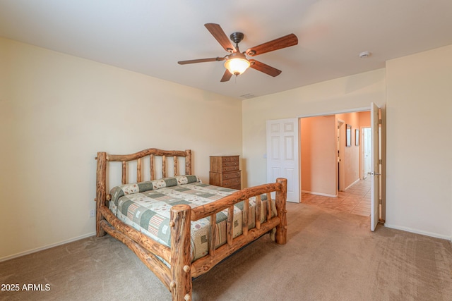 bedroom with light colored carpet, ceiling fan, and baseboards