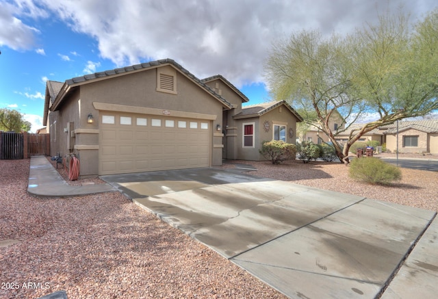 single story home with driveway, fence, an attached garage, and stucco siding