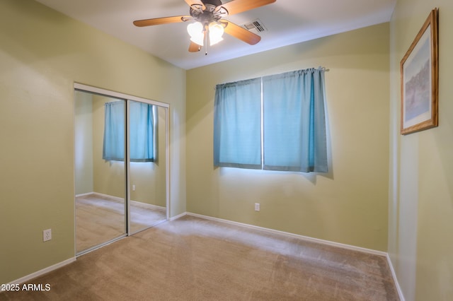 unfurnished bedroom with ceiling fan, carpet flooring, visible vents, baseboards, and a closet