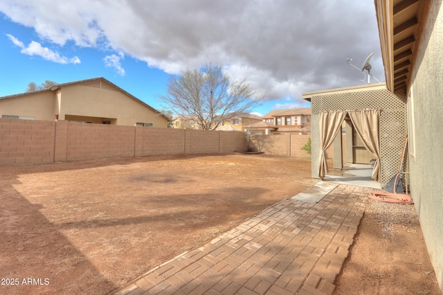 view of yard featuring a patio and a fenced backyard