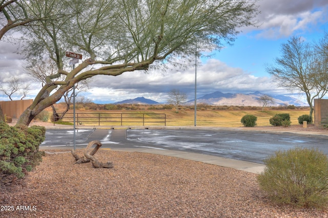 view of yard featuring fence and a mountain view