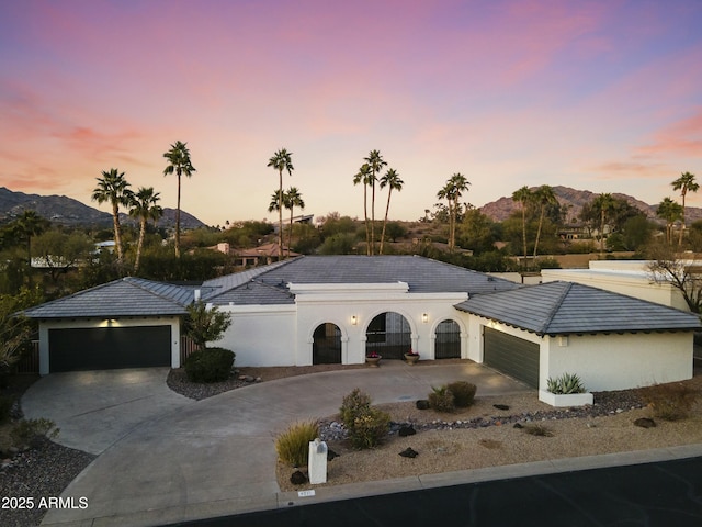 ranch-style home with a mountain view and a garage